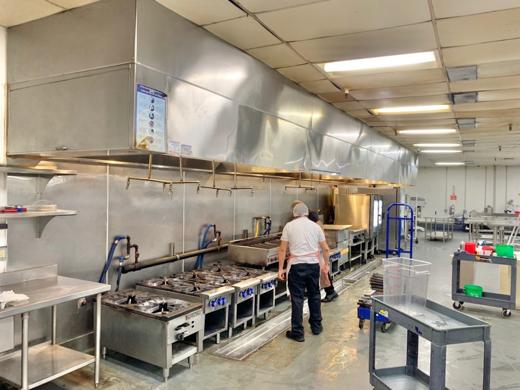 Long cooking hood in the commercial kitchen